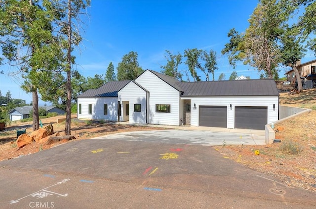 5351 Filbert St, Paradise, CA 95969 - modern farmhouse featuring a metal roof, concrete driveway, and a garage