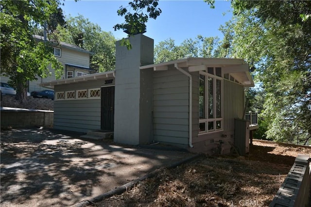 30607 Live Oak Dr, Running Springs, CA 92382 - view of property exterior with a chimney