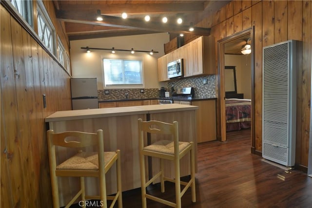 30607 Live Oak Dr, Running Springs, CA 92382 - kitchen with appliances with stainless steel finishes, a heating unit, backsplash, dark wood-type flooring, and wooden walls