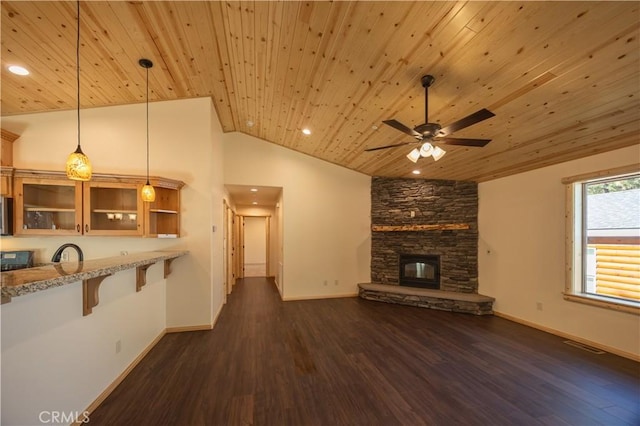 418 Los Angeles Ave, Sugarloaf, CA 92386 - unfurnished living room with wooden ceiling, vaulted ceiling, ceiling fan, a stone fireplace, and dark wood-style flooring