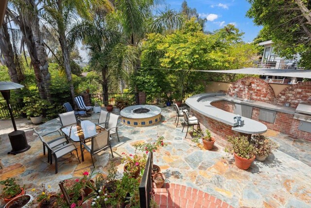 139 Parnassus Cir, Oceanside, CA 92054 - view of patio featuring an outdoor fire pit, exterior kitchen, and outdoor dining space
