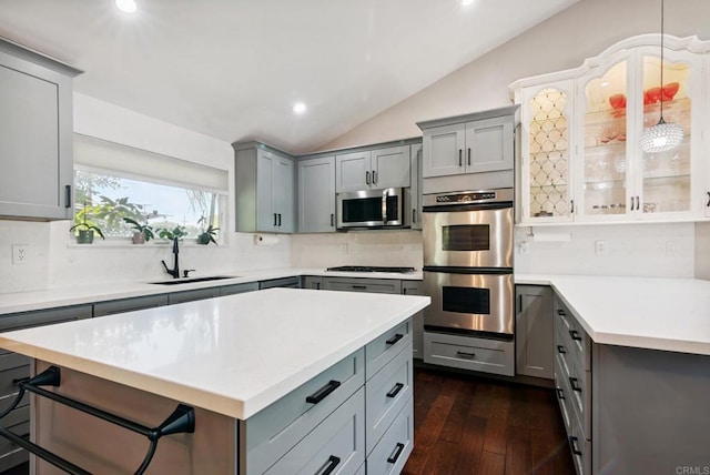 139 Parnassus Cir, Oceanside, CA 92054 - kitchen featuring appliances with stainless steel finishes, gray cabinets, lofted ceiling, decorative backsplash, and light countertops