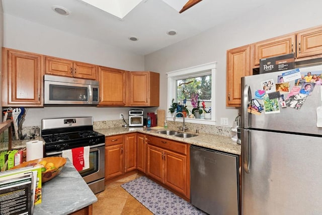 139 Parnassus Cir, Oceanside, CA 92054 - kitchen with appliances with stainless steel finishes, light stone countertops, and brown cabinets