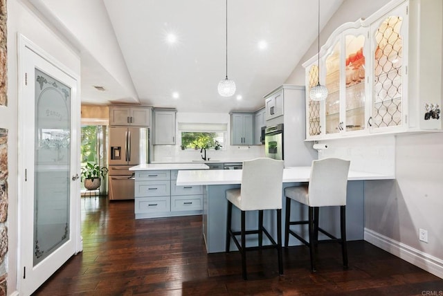139 Parnassus Cir, Oceanside, CA 92054 - kitchen with stainless steel appliances, lofted ceiling, light countertops, a peninsula, and a breakfast bar area
