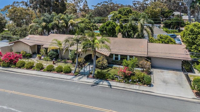 139 Parnassus Cir, Oceanside, CA 92054 - view of front of house featuring a tile roof, a fenced front yard, a chimney, an attached garage, and stucco siding