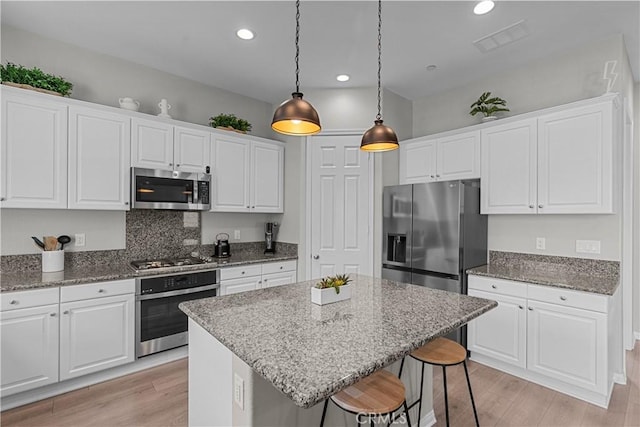 27422 Pioneer Ct, Valencia, CA 91381 - kitchen featuring stainless steel appliances, white cabinetry, light wood-style floors, and recessed lighting