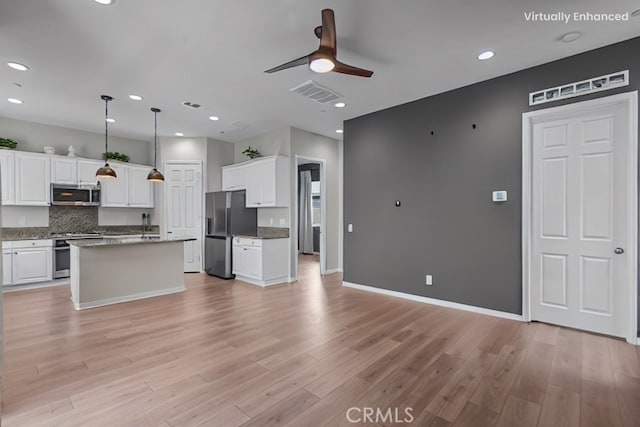 27422 Pioneer Ct, Valencia, CA 91381 - kitchen with stainless steel appliances, ceiling fan, white cabinets, light wood finished floors, and recessed lighting