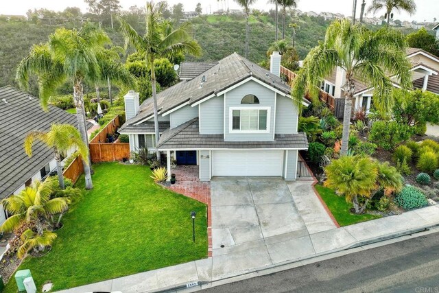 1592 Hawk View Dr, Encinitas, CA 92024 - view of front of home featuring an attached garage, driveway, and a chimney