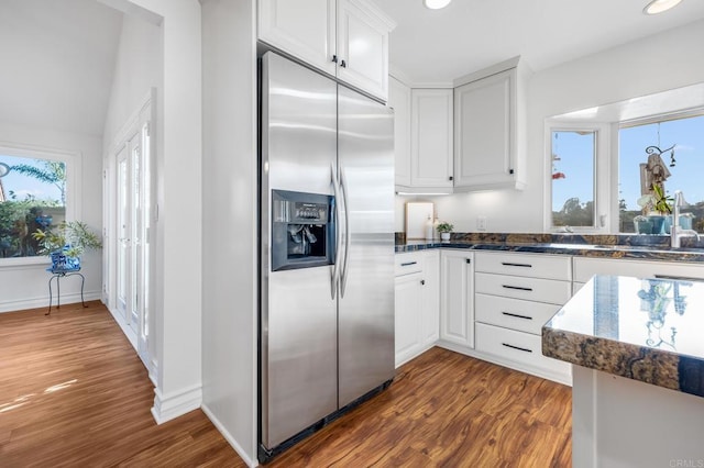 1592 Hawk View Dr, Encinitas, CA 92024 - kitchen with stainless steel fridge, dark wood finished floors, white cabinets, dark stone countertops, and recessed lighting