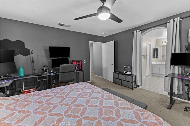 1142 Juniper Ct, San Jacinto, CA 92582 - carpeted bedroom with arched walkways, ensuite bath, and a ceiling fan