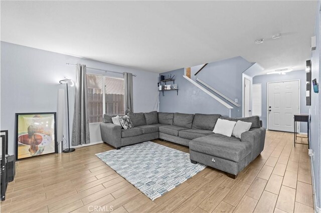 1142 Juniper Ct, San Jacinto, CA 92582 - living room with light wood finished floors and stairway