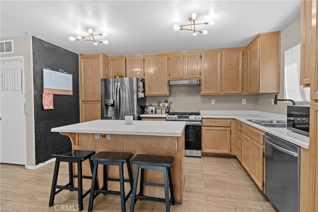 1142 Juniper Ct, San Jacinto, CA 92582 - kitchen featuring stainless steel appliances, a chandelier, light brown cabinetry, and light wood-type flooring