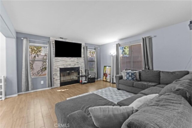 1142 Juniper Ct, San Jacinto, CA 92582 - living room featuring plenty of natural light, a fireplace, and wood finished floors