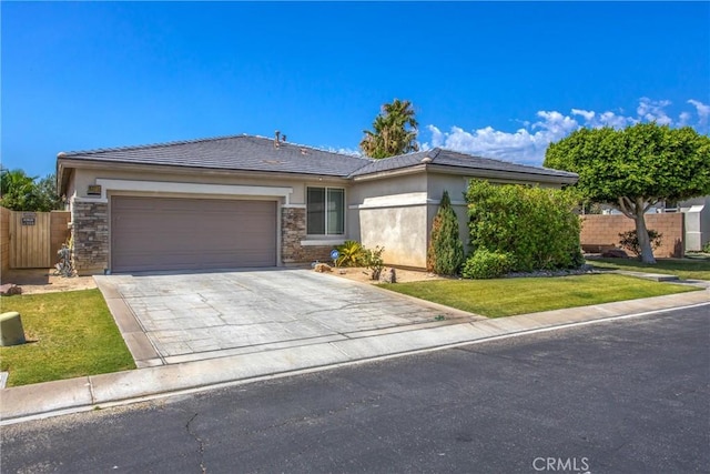 83315 Stagecoach Rd, Indio, CA 92203 - view of front of property featuring driveway, an attached garage, stucco siding, and a tiled roof