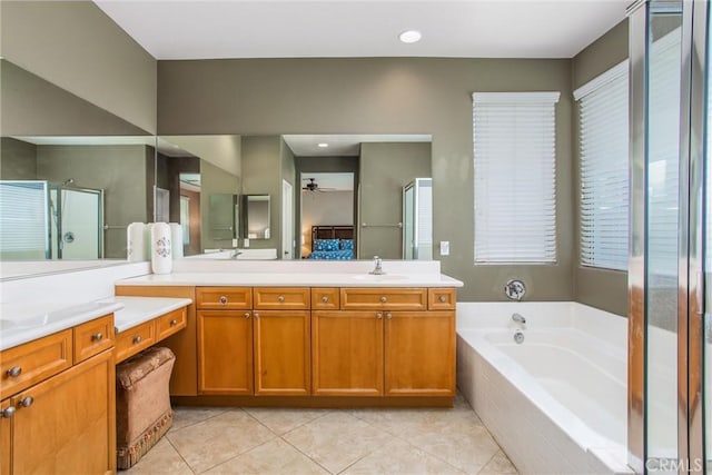83315 Stagecoach Rd, Indio, CA 92203 - bathroom with ceiling fan, double vanity, a bath, tile patterned floors, and a shower stall