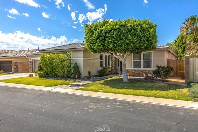 83315 Stagecoach Rd, Indio, CA 92203 - obstructed view of property featuring stucco siding, a garage, driveway, and a tiled roof