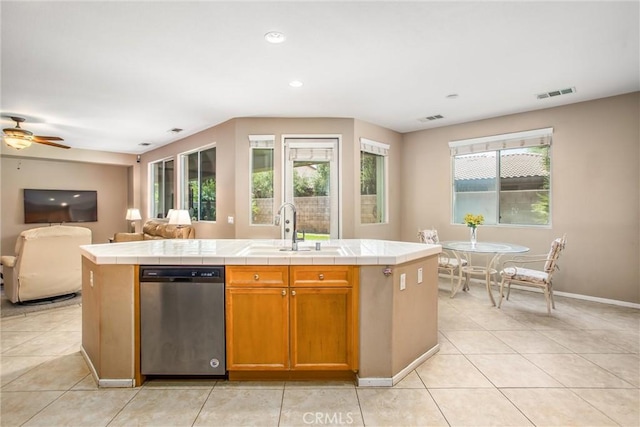 83315 Stagecoach Rd, Indio, CA 92203 - kitchen with stainless steel dishwasher, tile counters, open floor plan, light tile patterned floors, and recessed lighting