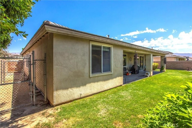 83315 Stagecoach Rd, Indio, CA 92203 - back of property with stucco siding, a patio, and a gate