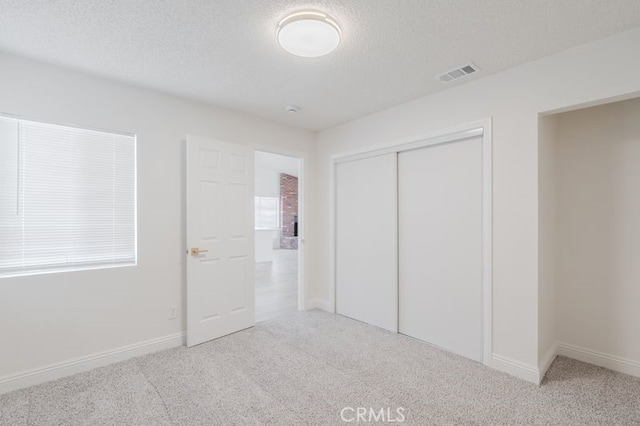 16233 Manzanita St, Hesperia, CA 92345 - unfurnished bedroom featuring carpet, a closet, and a textured ceiling