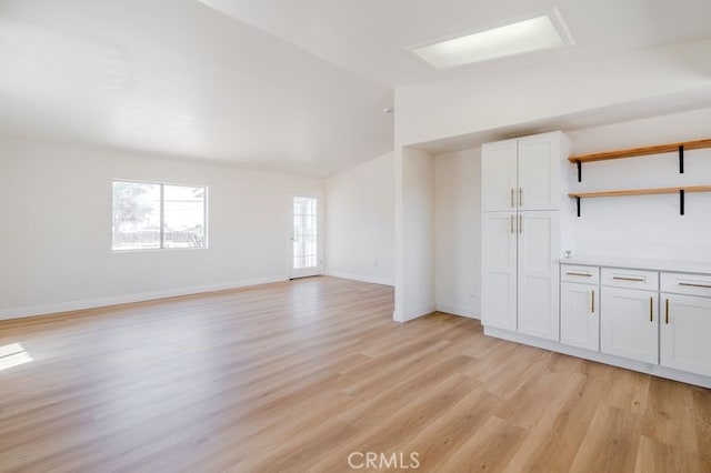16233 Manzanita St, Hesperia, CA 92345 - unfurnished living room with light wood-type flooring and lofted ceiling