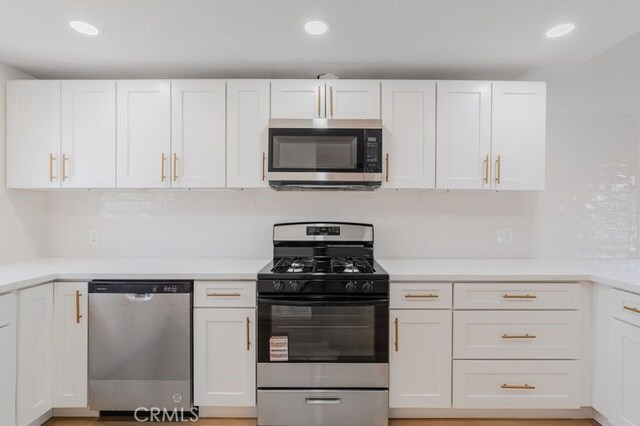 16233 Manzanita St, Hesperia, CA 92345 - kitchen with appliances with stainless steel finishes, white cabinetry, light countertops, and recessed lighting