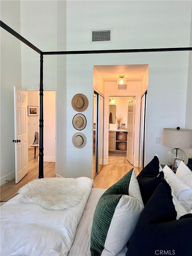 76376 Sweet Pea Way, Palm Desert, CA 92211 - bedroom featuring light wood-style floors, a high ceiling, and connected bathroom