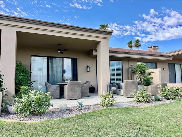 76376 Sweet Pea Way, Palm Desert, CA 92211 - back of property with a ceiling fan, stucco siding, a patio, a lawn, and a chimney