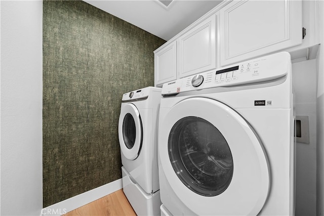 33 Winterfield Rd, Irvine, CA 92602 - laundry room with washer and clothes dryer, cabinet space, and light wood finished floors