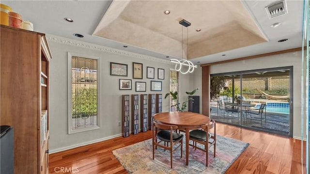 4968 Chapala Dr, Riverside, CA 92507 - dining area featuring a tray ceiling, wood finished floors, crown molding, and recessed lighting