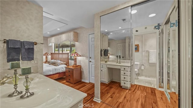 4968 Chapala Dr, Riverside, CA 92507 - bathroom featuring wood finished floors, vanity, and ensuite bathroom