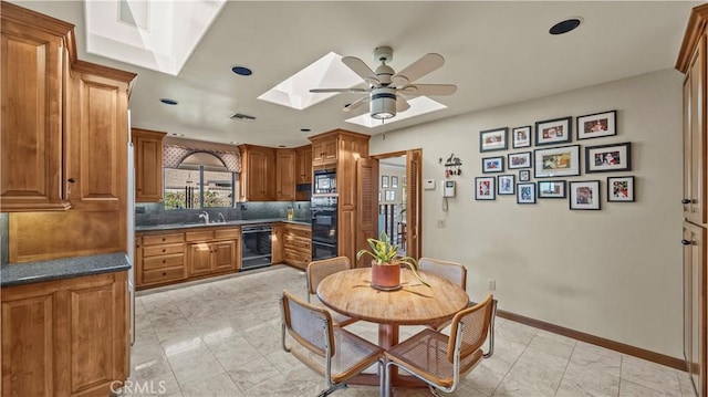 4968 Chapala Dr, Riverside, CA 92507 - dining space featuring a skylight, a ceiling fan, light marble finish floors, and recessed lighting