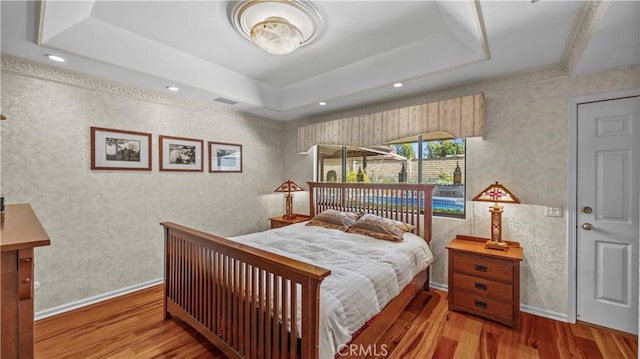 4968 Chapala Dr, Riverside, CA 92507 - bedroom featuring a tray ceiling, wood finished floors, wallpapered walls, and recessed lighting