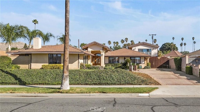 4968 Chapala Dr, Riverside, CA 92507 - ranch-style home featuring a chimney, stucco siding, driveway, and a gate