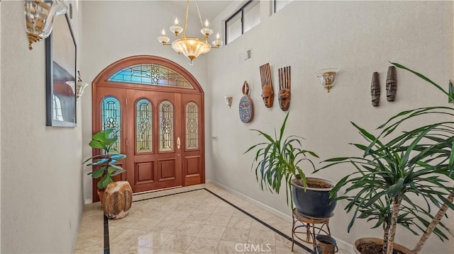 4968 Chapala Dr, Riverside, CA 92507 - foyer with inlaid floor details, healthy amount of natural light, a chandelier, and a towering ceiling