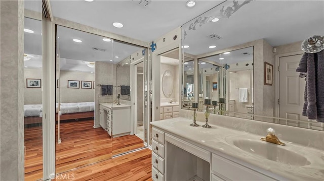 4968 Chapala Dr, Riverside, CA 92507 - ensuite bathroom featuring wood finished floors, vanity, recessed lighting, and a shower with door