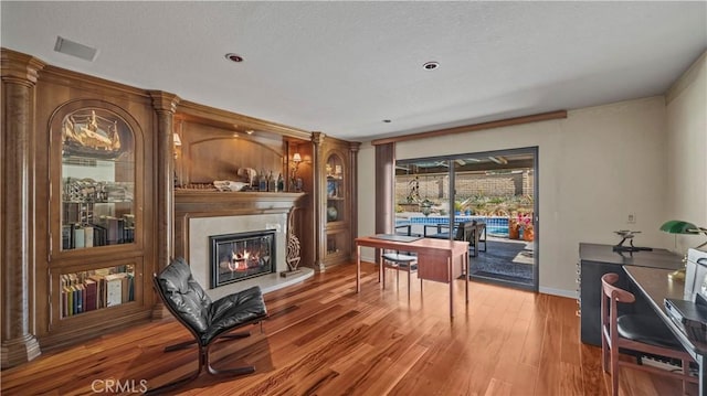 4968 Chapala Dr, Riverside, CA 92507 - living room with a premium fireplace, wood finished floors, and a textured ceiling