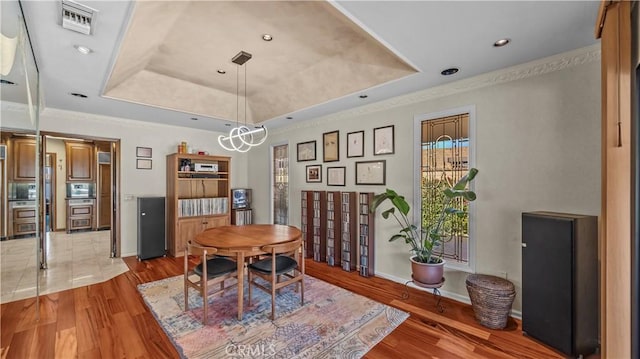 4968 Chapala Dr, Riverside, CA 92507 - dining space with a raised ceiling, wood finished floors, crown molding, and recessed lighting