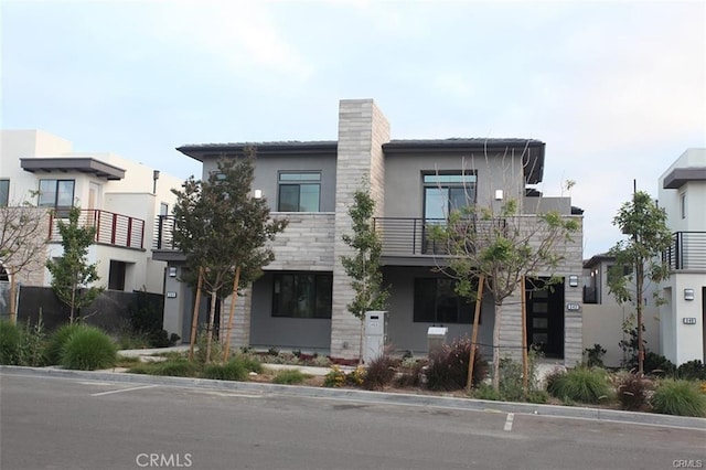 342 Magnet, Irvine, CA 92618 - modern home with stucco siding, a balcony, and stone siding
