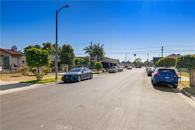 629 E 93rd St, Los Angeles, CA 90002 - view of asphalt street with curbs, sidewalks, and street lighting