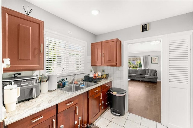 629 E 93rd St, Los Angeles, CA 90002 - kitchen featuring light tile patterned flooring, tasteful backsplash, light stone countertops, and recessed lighting