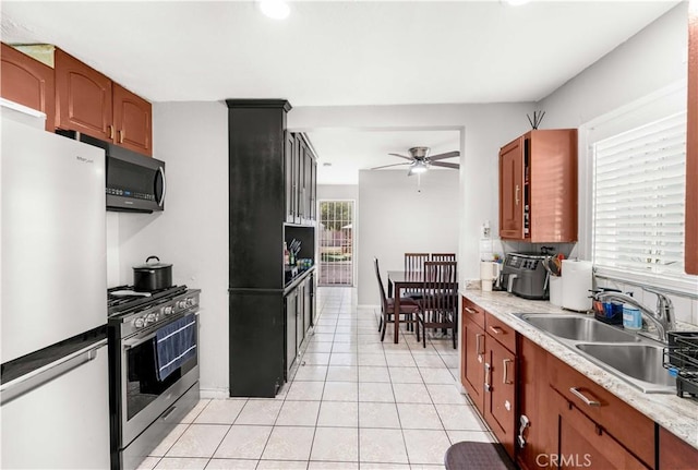 629 E 93rd St, Los Angeles, CA 90002 - kitchen featuring stainless steel appliances, ceiling fan, light tile patterned floors, light countertops, and recessed lighting