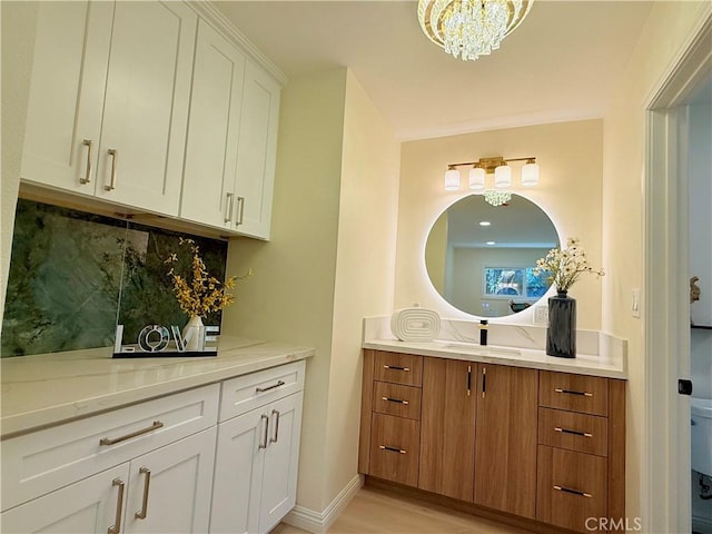 1319 Riedel Ave, Fullerton, CA 92831 - bathroom featuring vanity, tasteful backsplash, a chandelier, and wood finished floors