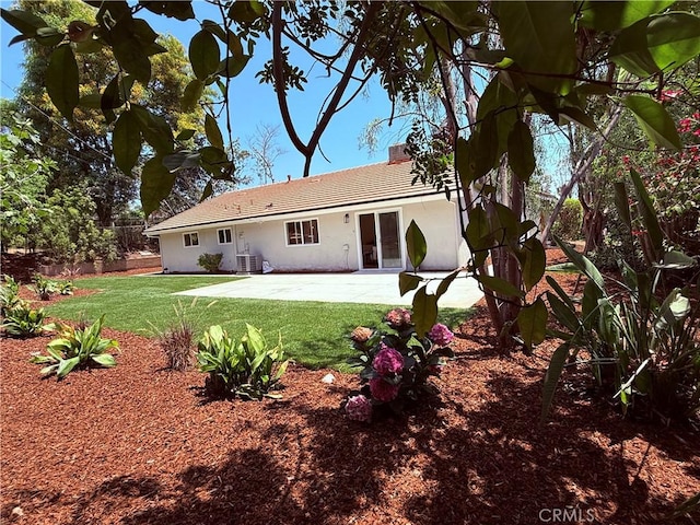 1319 Riedel Ave, Fullerton, CA 92831 - back of property with a chimney, a yard, stucco siding, a patio, and a tiled roof