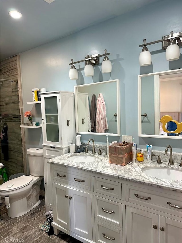 14811 Alexander St, San Fernando, CA 91345 - bathroom with double vanity, a shower stall, and wood finish floors