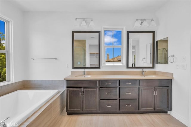 65 Rexford, Irvine, CA 92620 - bathroom with double vanity, a garden tub, and a shower with shower door