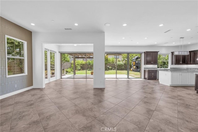 65 Rexford, Irvine, CA 92620 - unfurnished living room with recessed lighting and light tile patterned floors