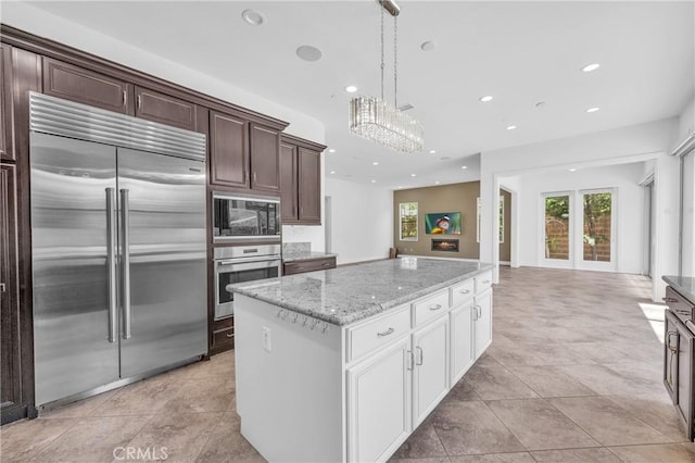 65 Rexford, Irvine, CA 92620 - kitchen featuring built in appliances, healthy amount of natural light, recessed lighting, a kitchen island, and light stone countertops