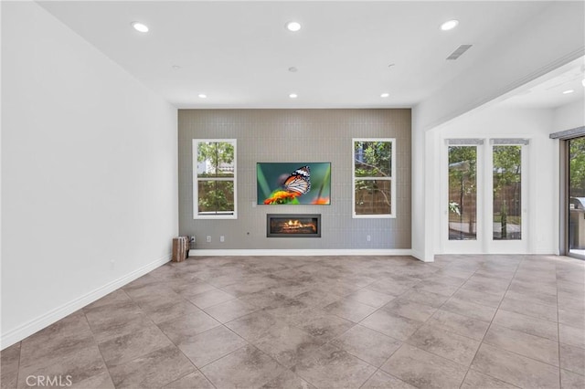 65 Rexford, Irvine, CA 92620 - unfurnished living room with recessed lighting and a glass covered fireplace