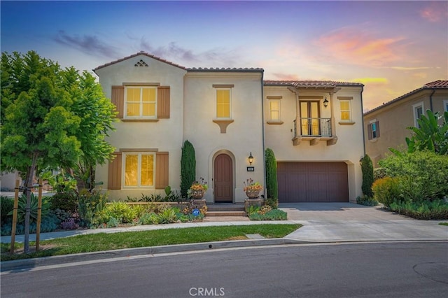65 Rexford, Irvine, CA 92620 - mediterranean / spanish home with a balcony, stucco siding, concrete driveway, and a garage