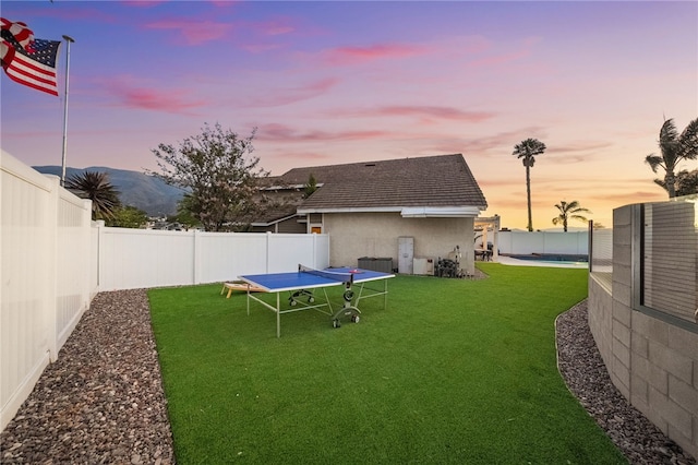 747 Highland View Dr, Corona, CA 92882 - yard at dusk featuring a trampoline, a fenced backyard, and a mountain view
